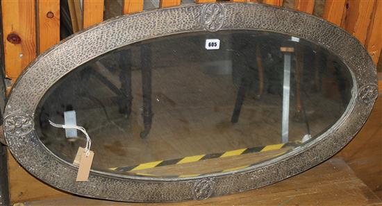 Oval metal framed wall mirror